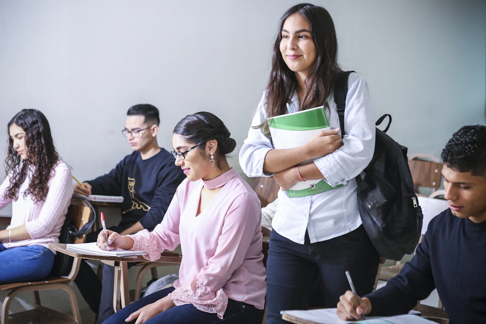 Estudantes adultos em sala de aula fazendo anotações